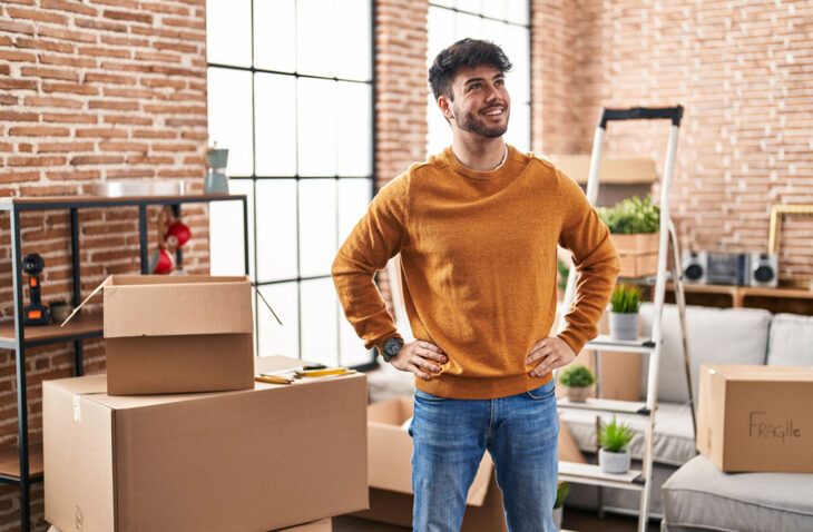 Guy smiling moving in to his first apartment