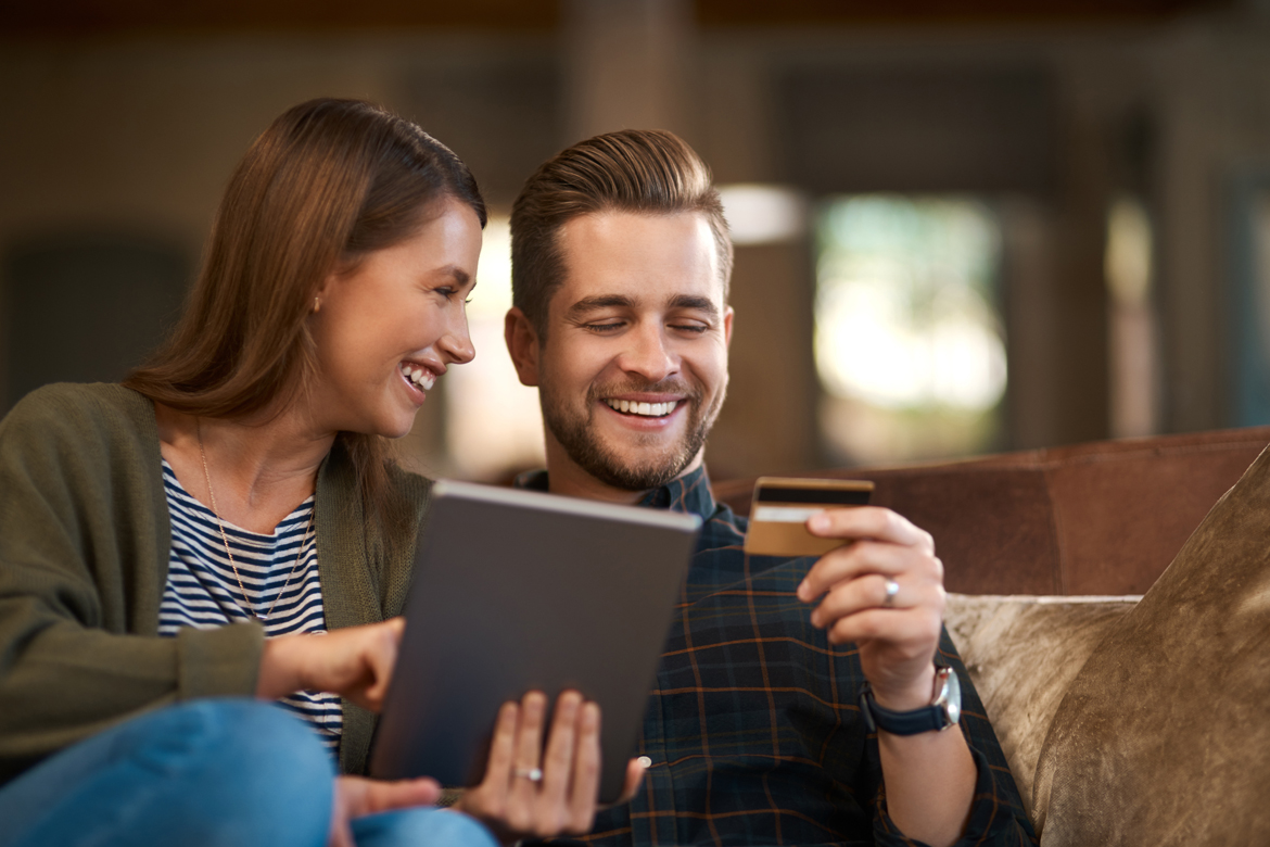 Pareja mirando tableta y tarjeta de crédito